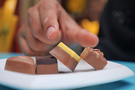 Enjoying a selection of handmade chocolates at a cafeの写真素材