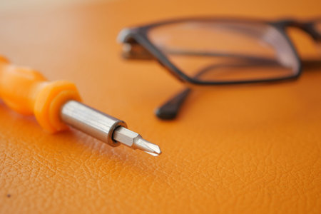 Close up of tools and glasses on an orange surfaceの写真素材