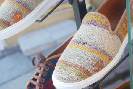 Colorful handmade shoes displayed in a shop window