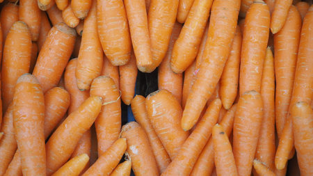 Fresh carrots piled together at a local market