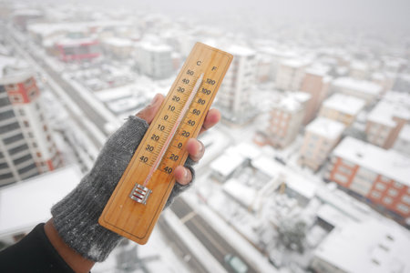 Cold winter temperature reading in a snowy cityの写真素材