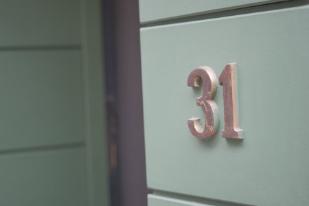 House number 31 displayed on a green wallの写真素材