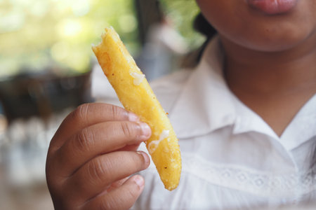 Child enjoying a delicious snack at a casual setting