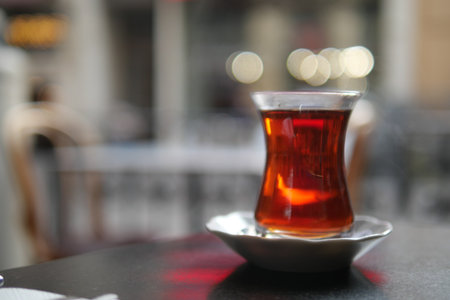 Turkish tea served in glass cup at a cozy cafe settingの写真素材