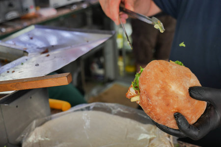Making a delicious sandwich at a local market stallの写真素材