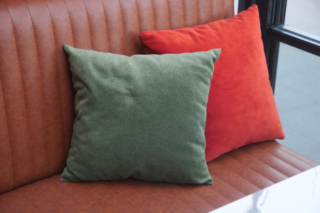 Stylish cushions on a cozy bench in a modern spaceの写真素材