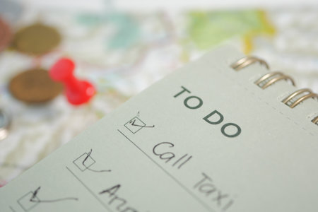 Checklist for daily tasks with coins and pins visibleの写真素材