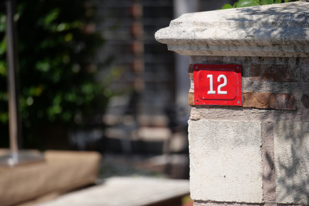 House number 12 on a sunny day in a quiet neighborhoodの写真素材