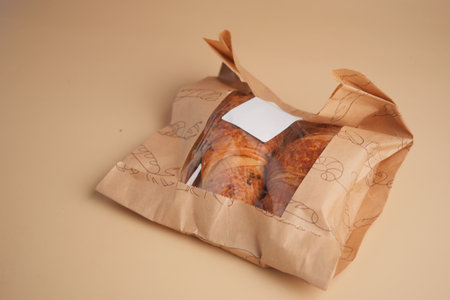 Freshly baked croissants in paper packaging for takeoutの写真素材