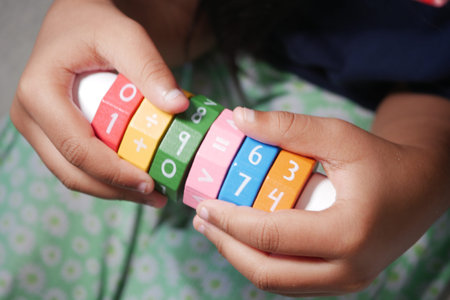 Colorful counting toy held by child in playful settingの写真素材