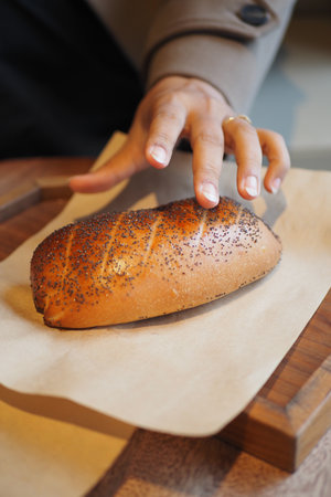 Freshly baked bread on a wooden board in a cafeの写真素材