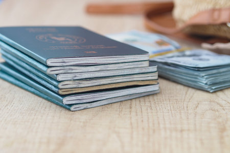 Multiple passports and currencies on a wooden table