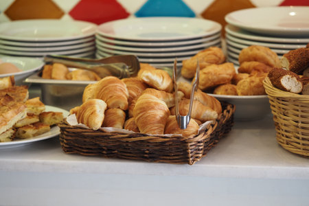 Delicious pastries displayed on a breakfast buffet tableの写真素材