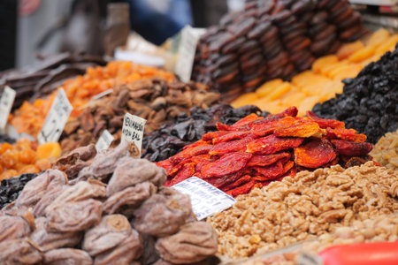 Explore colorful dried fruits at a market stallの写真素材