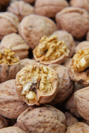 Walnuts in their shells at a local marketの写真素材