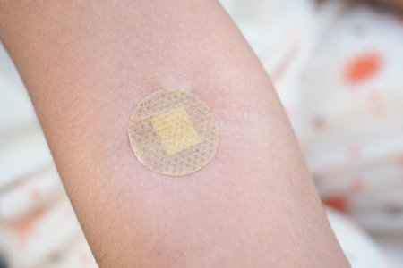 Bandage on skin after a minor injury during the dayの写真素材