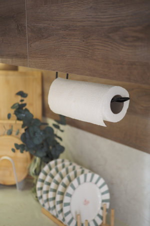 Kitchen scene with paper towel holder and dishware displayの写真素材