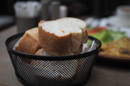 Freshly baked bread served in a basket at a cafeの写真素材