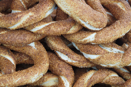 Sesame-covered bread rings stacked in a marketの写真素材