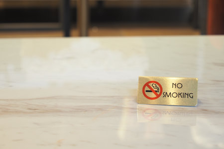 No smoking sign on a marble table in a restaurantの写真素材