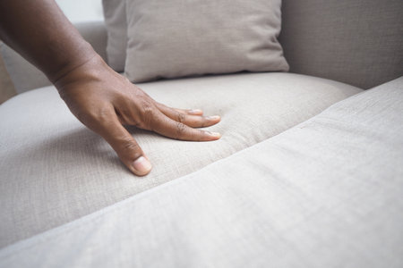 Touching a soft fabric on a modern sofaの写真素材