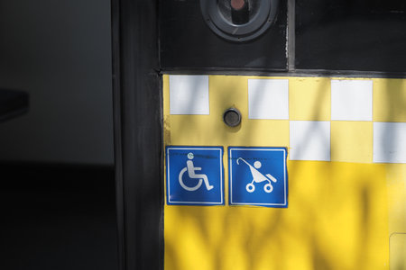 Accessibility symbols on a public transport stop in daylightの写真素材