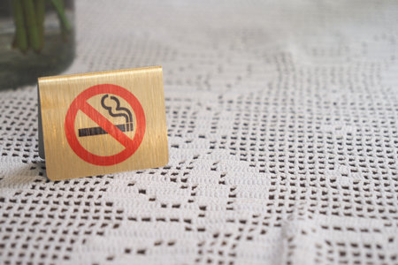No smoking sign on a textured tablecloth in a cafeの写真素材