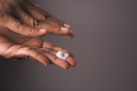 Applying moisturizing cream on the hand for skin careの写真素材