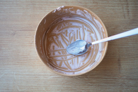 Empty bowl with spoon shows finished dessert preparationの写真素材