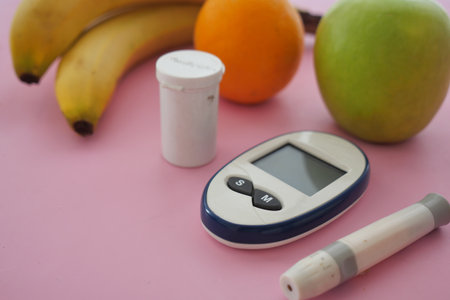 Health tools and fruits on a pink surface for wellness checkの写真素材