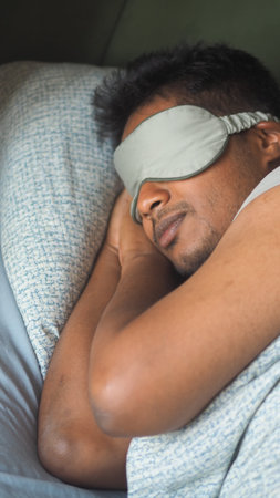 Cozy man sleeping peacefully with a sleep mask