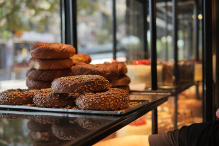 Freshly baked bagels in a bakery display case