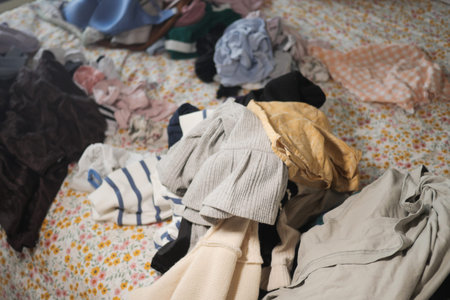 Sorting clothes and organizing laundry on a bed