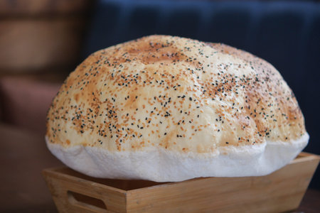Freshly baked bread with herbs on wooden tray