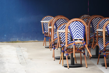 Empty cafe chairs waiting for customers on a sunny dayの写真素材