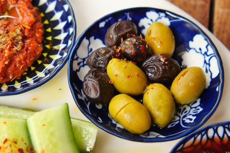 Olives with dips and cucumber slicesの写真素材