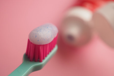 Toothbrush with toothpaste on a pink backgroundの写真素材
