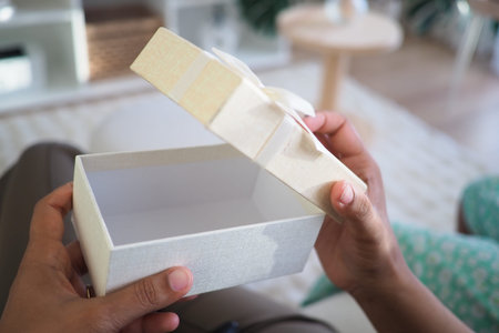 Gift box opening in a cozy living room setting