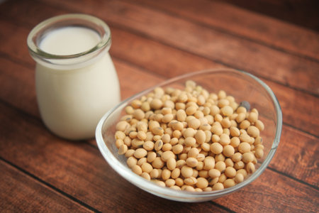 Soybeans and soy milk on a wooden table displayの写真素材