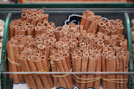 Colorful display of cinnamon sticks at a market standの写真素材