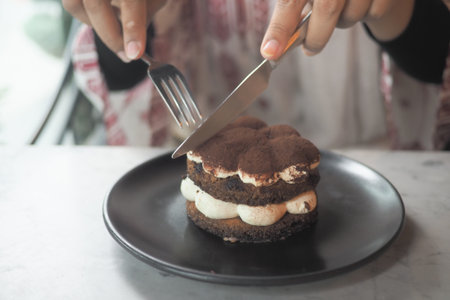 Enjoying a delicious dessert at a cozy cafeの写真素材