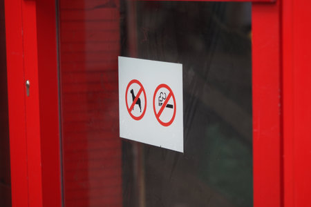 No smoking and no pets signs on a red doorの写真素材