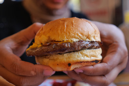 Cheesy burger in a casual diner settingの写真素材