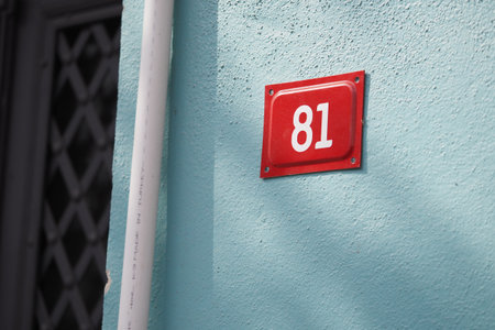 House number 81 on a vibrant blue wallの写真素材
