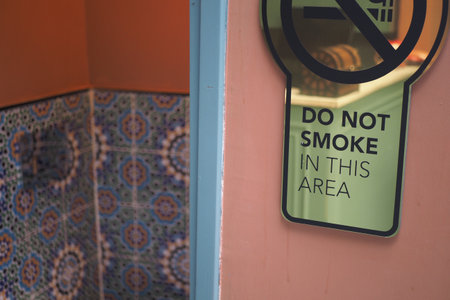 Sign indicating no smoking policy in a public restroomの写真素材