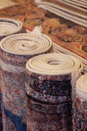Colorful rolls of traditional rugs display craftsmanshipの写真素材