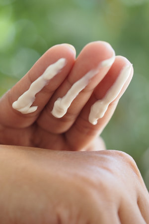 Sunscreen Cream applied to fingers for skincare routineの写真素材