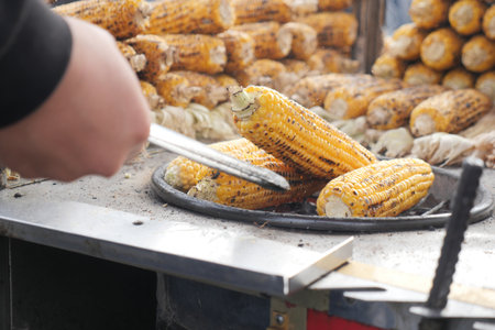 Grilling corn at a street market in the afternoonの写真素材