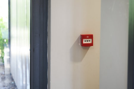 Emergency alarm box on the wall in a building hallwayの写真素材