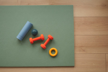 Workout equipment on green exercise mat in simple layoutの写真素材
